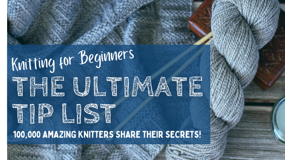 skein of gray yarn, knitting needles and knit blanket on table