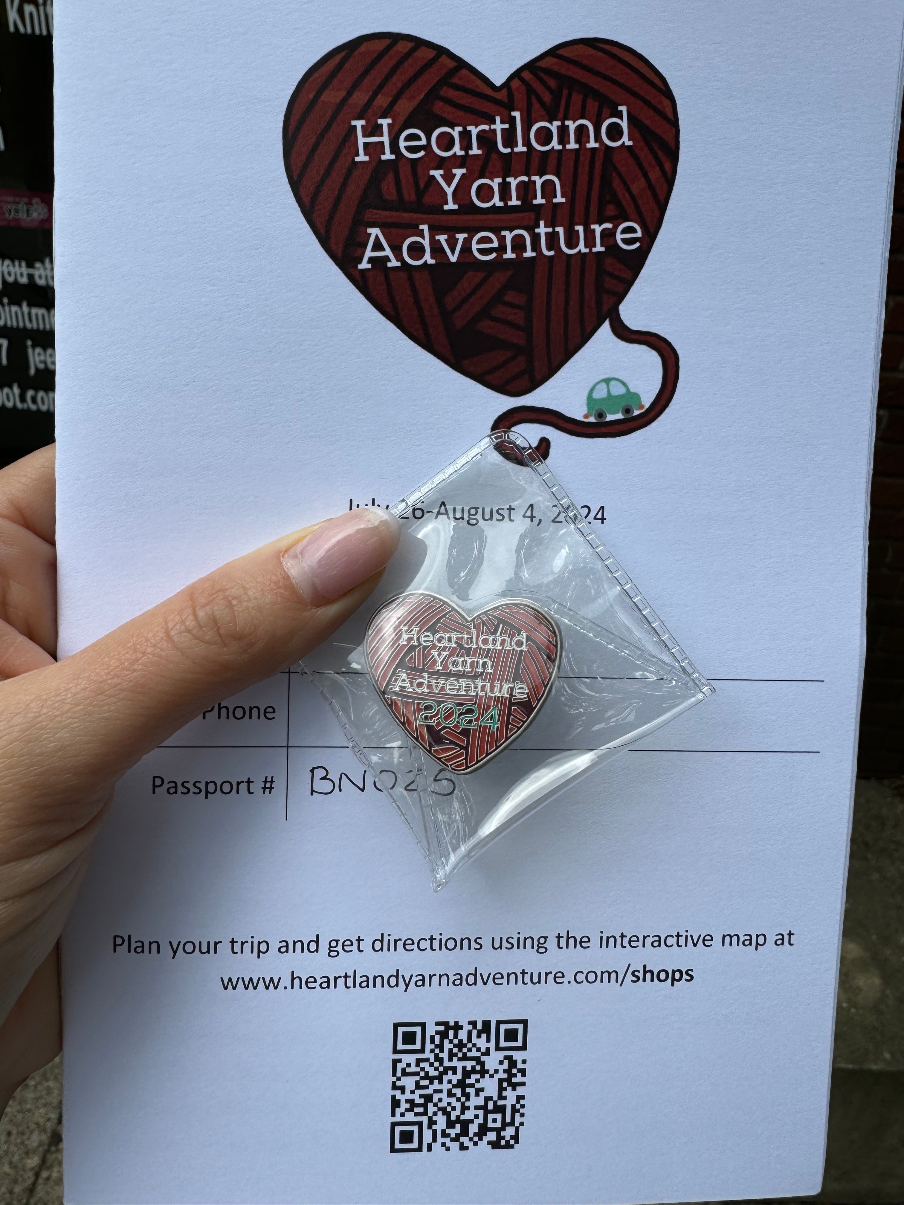 2024 Heartland Yarn Adventure Shop guide map and souvenir pin.